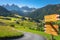 St. Magdalena village road sign with church in Val di Funes, Dolomites , Italy