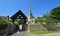 St Margarets church and Lychgate at Hemmingford Abbots Cambridgeshire England blue sky and grave stones.