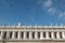 St Mark`s Square, Venice, Italy. Bird flies across blue sky