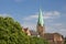 St. Martin`s Church, Bremen, Germany viewed from the river Weser with lush green foliage in the foreground