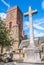 St. Mary`s Church Petworth. West Sussex England, UK. Clock tower and stone cross