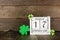 St Patrick Day on a rustic shabby chic calendar with shamrocks against dark wood