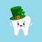 St Patrick day tooth in green leprechaun hat with shamrock.