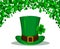 St. Patrick`s Day background made of four leaf clover. and Patrick green hat in the center