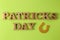 St.Patrick `s Day. celebration. golden horseshoe and text on a bright green background. top view