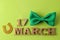 St.Patrick `s Day. celebration. Green bow tie and horseshoe and text March 17 on a bright green background. view from above