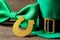 St.Patrick `s Day. celebration. Green hat of a leprechaun and tie butterfly and horseshoe on a brown background. close-up