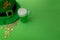 St Patrick`s Day green beer with shamrock, pot with gold coins, horseshoe and Leprechaun hat against green background.