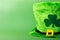 St.Patrick 's Day . hat with clover on green background