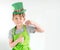 St Patrick`s Day holiday concept. Joyful emotional caucasian blond boy with green paper leprechaun hat with clover on