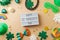 St Patrick`s day holiday frame border background with lightbox, lucky charms, shamrock and  rainbow. Top view, flat lay