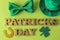 St.Patrick `s Day. holiday. Green hat of leprechaun, clover, butterfly tie, horseshoe and text on a bright green background. top