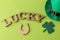 St.Patrick `s Day. holiday. Green hat of leprechaun, horseshoe and text on a bright green background. view from above