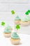 St. Patrick`s Day theme colorful vertical banner. Cupcakes decorated with green buttercream and craft felt decorations in form of