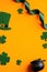 St Patricks day banner design. Top view pot of gold, shamrock leaves, leprechaun hat on orange background. Saint Patrick`s day