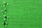 St Patricks Day border of paper shamrocks on green burlap