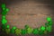 St Patricks Day border of shamrocks on vintage style wood background.