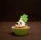 St. Patricks Day Cupcake decorated with Shamrocks isolated on Dark Rustic Wood Table and Background with copy space