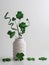 St. Patrickâ€™s Day green swirls, four leaf clovers and a hat in a white vase with more glittery green four leaf clovers on a