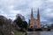 The St. Paul`s Church of Strasbourg, French Eglise reformee Saint-Paul and river bank with park in spring in dusk rainy day,