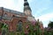 St. Peter`s Church in summer time. View through flowers. Focus