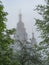 St. Petersburg, Peterhof at dawn in the summer in the fog. Thick white fog on the Olga Pond, the Cathedral of Peter and Paul in th