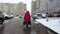 St. Petersburg  Russia 01.10.2021 An elderly woman walks near the wall of a multi-storey building on a frozen and slippery