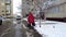 St. Petersburg  Russia 01.10.2021 An elderly woman walks near the wall of a multi-storey building on a frozen and slippery