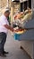 St. Petersburg, Russia - June 5, 2019, a tanned Caucasian old man selling fresh fruits and vegetables at a street market