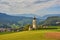 St. Valentin Kastelruth Village Church in the summer in the Dolomite Alps. Amazing landscape with small chapel on sunny meadow and