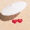 St. Valentine Day and February 14th greeting card. Two red hearts under beach umbrella. Romantic travel for love couple