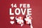 St. Valentines Day background with date, word love, gifts and decorative hearts on red