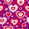 St Valentineâ€™s Day. Seamless pattern with red and pink hearts. Purple background. Decorative ornament. Love and romance.