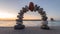 Stability stone arch with red stone at top in the morning on a beach. Wellness and nature concept. Balance concept.