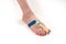 Stabilizing orthosis for the correction of the big toe on the woman leg when hallux valgus, 1 foot, close-up isolated, white