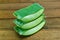 Stack of Aloe vera sliced on wooden background.