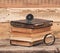 Stack of antique books with magnifying glass