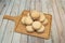 Stack of Argentine alfajores filled with chocolate and coconut shavings on bamboo wood board