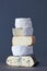 Stack Of Artisan Organic Cheese Against Grey Background