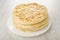 Stack of baked flatbreads khachapuri in white plate on wooden table