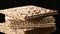 Stack of baked square matzo rotate on black background, kosher food