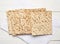 Stack of baked square matzo on a white wooden background