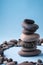 Stack balance of pebbles calm therapy on blue background