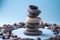 Stack balance of pebbles calm therapy on blue background