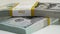 Stack of bank bundles with US dollars on a white background. Close-up shot of new, freshly printed hundred-dollar bills