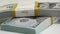 stack of bank bundles with US dollars on a white background. Close-up shot of new, freshly printed hundred-dollar bills