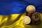 Stack of Bitcoin coins on Ukrainian flag. Situation of Bitcoin and other cryptocurrencies in Ukraine