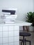 Stack of black and white mockup books on white counter bar in white cafe background minimal style