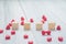 Stack of blank wood cube with group of mini red heart on white r