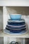 Stack of blue plates in a cabinet